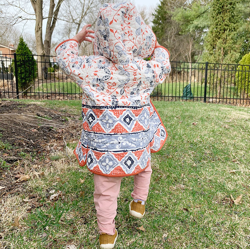 daughter wearing tamarack jacket walking away