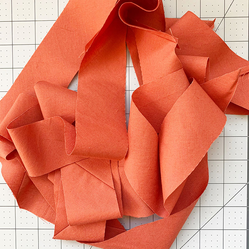 reveal: pile of bias tape made using the continuous bias tape method