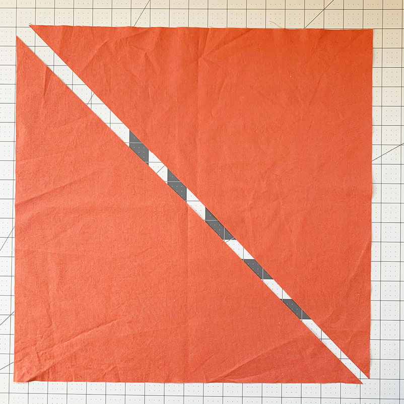 square of fabric cut on the diagonal