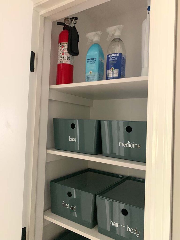 top shelf with fire extinguisher and cleaning supplies