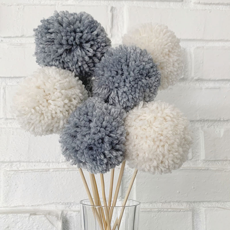 final bouquet made with blue and white pom poms on skewers