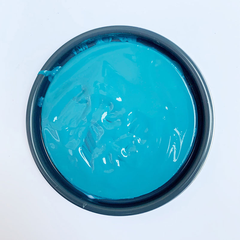 opened paint can lid with blue paint on it