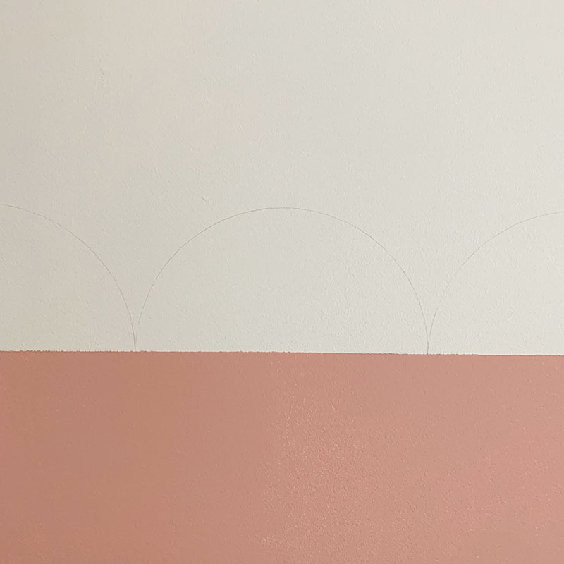 scalloped stencil markings on wall