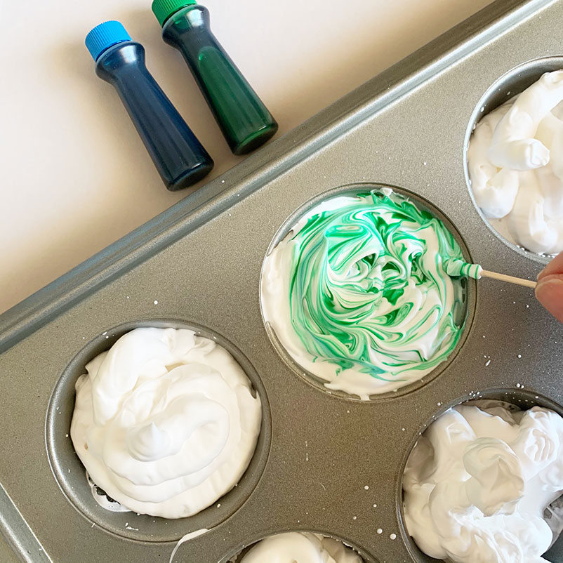 swirl food coloring to dye eggs with shaving cream