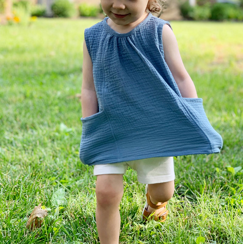 Toddler girl running with hands in pockets