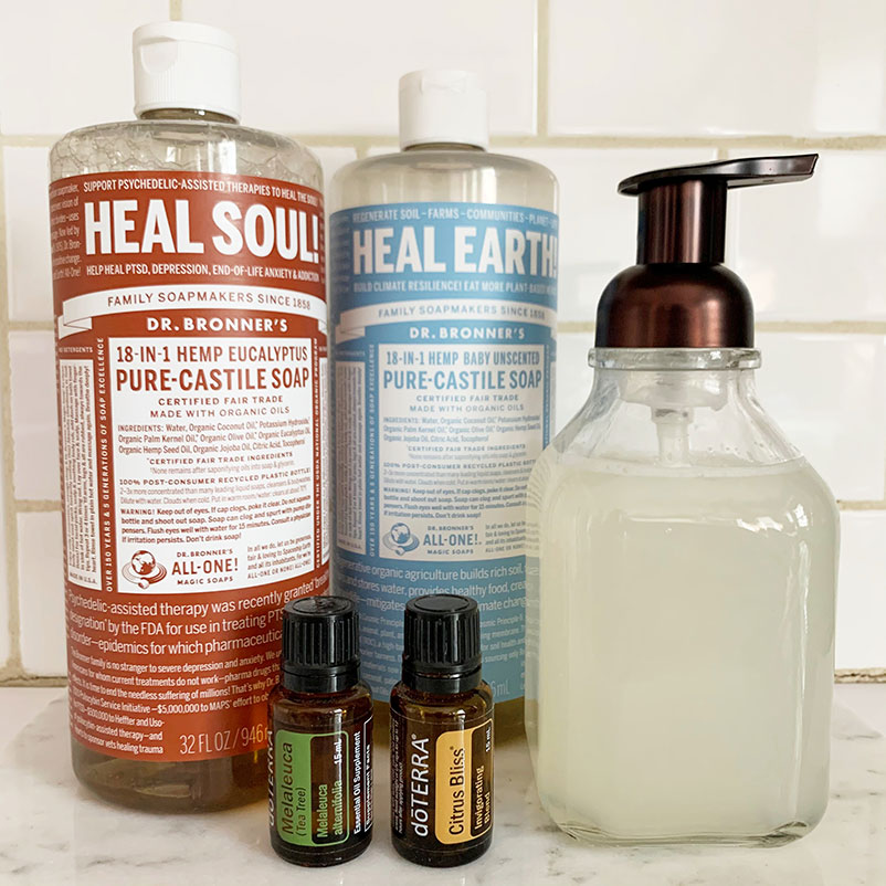 dr. bonners soap, essential oils, and foaming hand soap on countertop