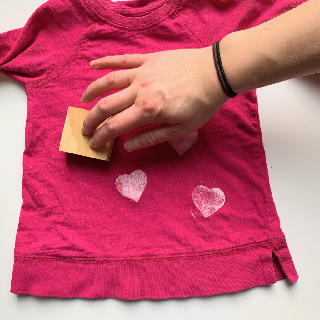 heart stamps placed onto child's t-shirt